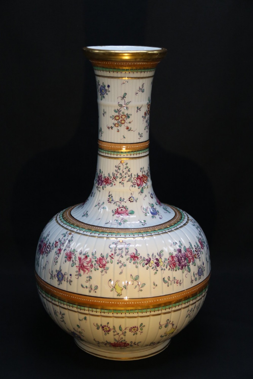 A bulbous hand-painted white porcelain vase with vertical fluting, decorated with floral sprigs and gold gilded borders. View III