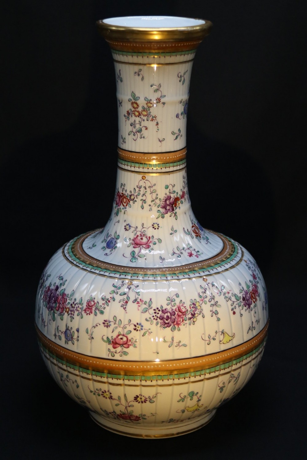 A bulbous hand-painted white porcelain vase with vertical fluting, decorated with floral sprigs and gold gilded borders. View V