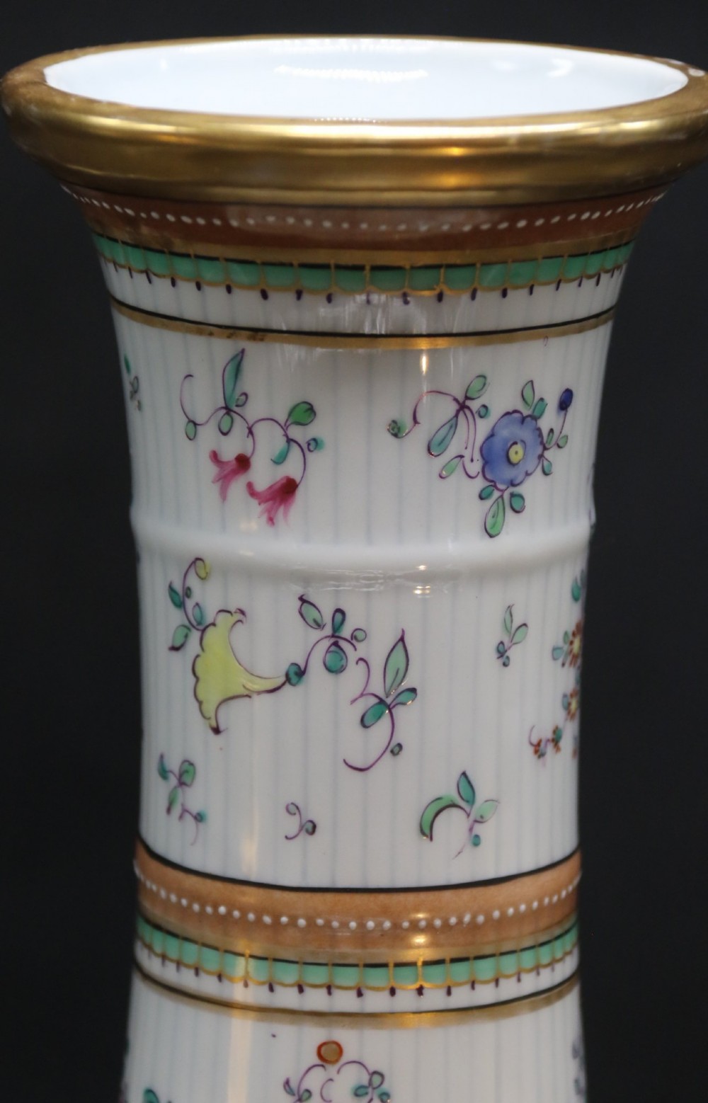 A bulbous hand-painted white porcelain vase with vertical fluting, decorated with floral sprigs and gold gilded borders. View VII