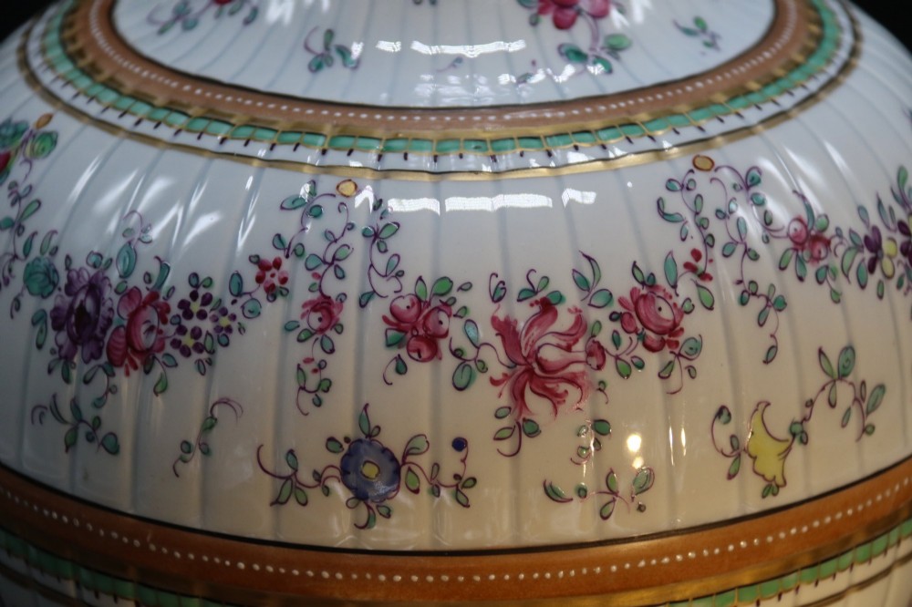 A bulbous hand-painted white porcelain vase with vertical fluting, decorated with floral sprigs and gold gilded borders. View IX