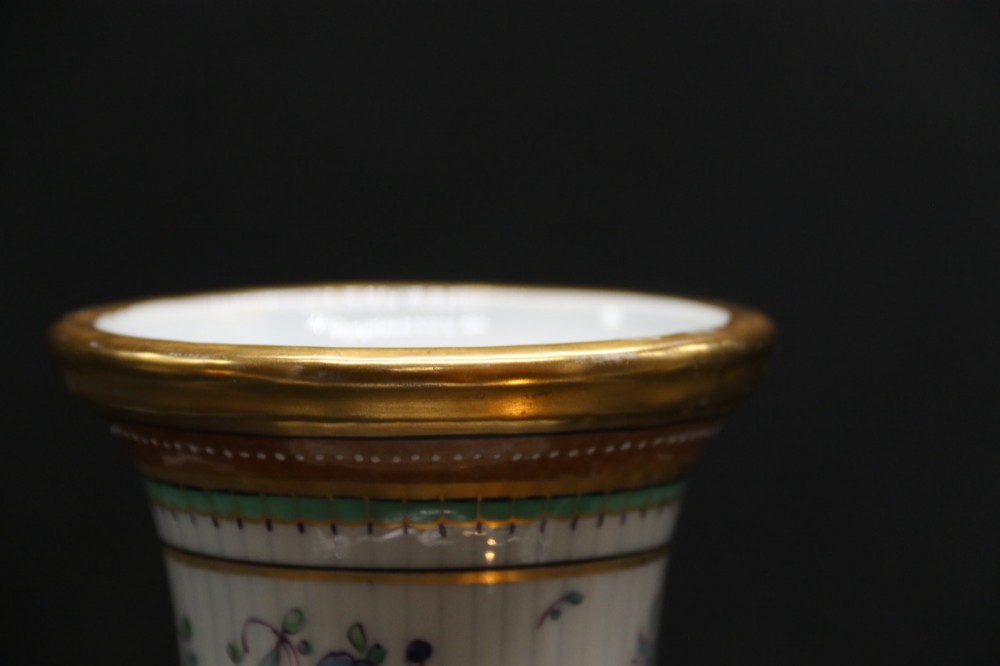 A bulbous hand-painted white porcelain vase with vertical fluting, decorated with floral sprigs and gold gilded borders. View XI