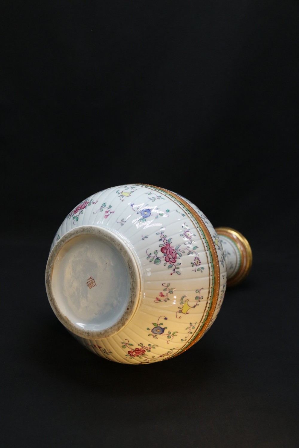 A bulbous hand-painted white porcelain vase with vertical fluting, decorated with floral sprigs and gold gilded borders. View XII