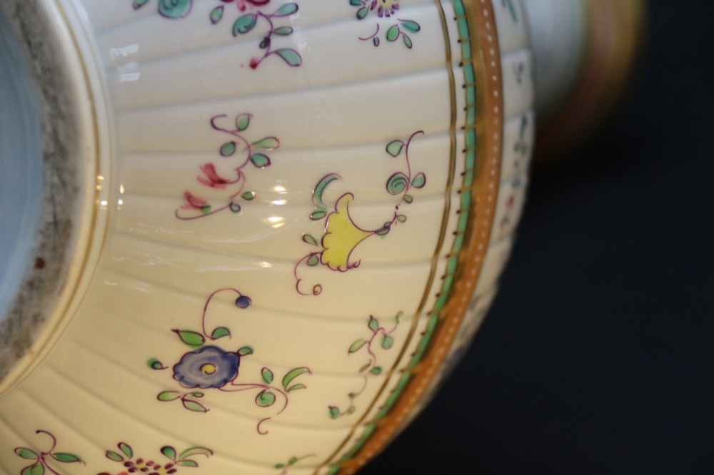 A bulbous hand-painted white porcelain vase with vertical fluting, decorated with floral sprigs and gold gilded borders. View XIV