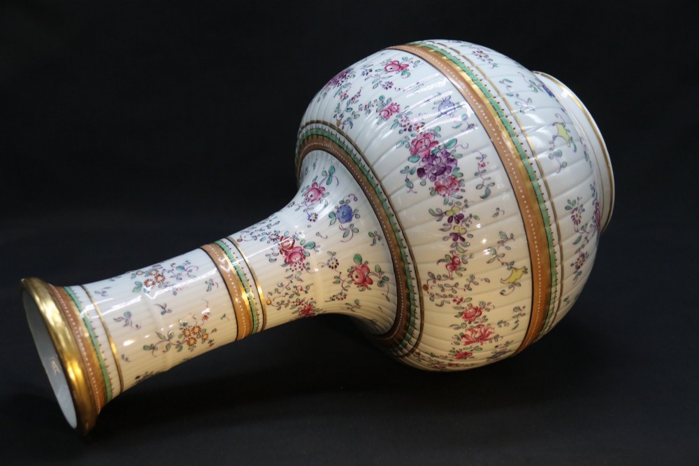 A bulbous hand-painted white porcelain vase with vertical fluting, decorated with floral sprigs and gold gilded borders. View XV