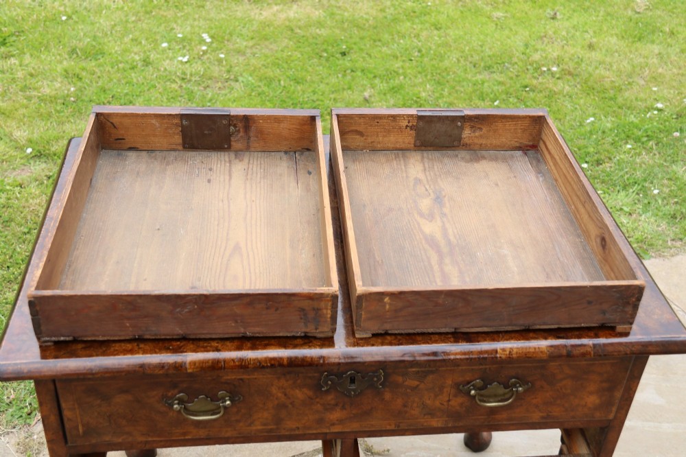 A George II burr elm lowboy featuring three drawers, brass drop handles, a scalloped apron, and cabriole legs terminating in pad feet. View XIII