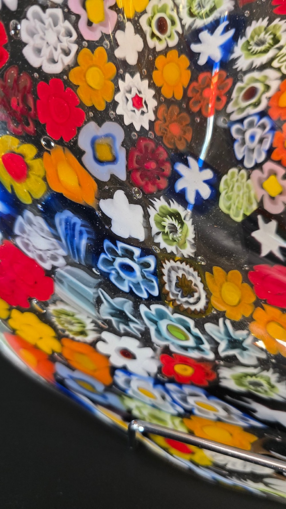 A circular Murano millefiori glass bowl featuring dense, colourful mosaic cane patterns arranged in starburst and floral formations. View VIII