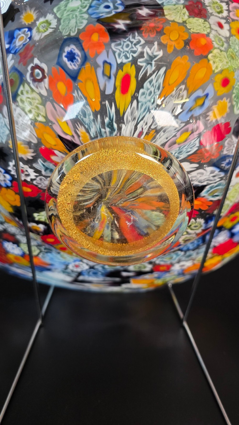A circular Murano millefiori glass bowl featuring dense, colourful mosaic cane patterns arranged in starburst and floral formations. View XI