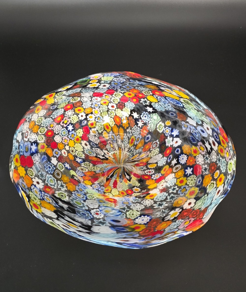 A circular Murano millefiori glass bowl featuring dense, colourful mosaic cane patterns arranged in starburst and floral formations. View XIII