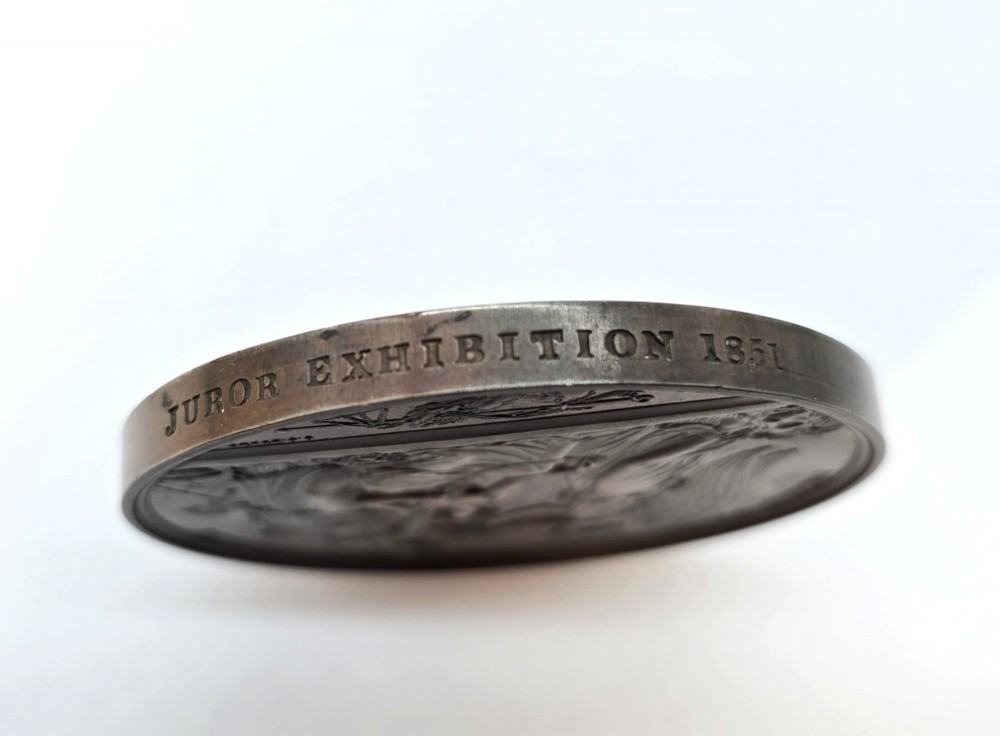 A circular dark bronze Victorian medal displaying jugate profile portraits of Queen Victoria and Prince Albert surrounded by Latin text. View III