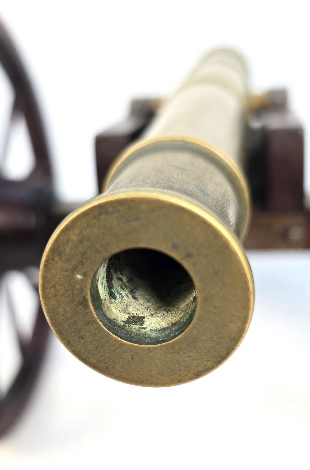 A pair of 1920s model field cannons featuring cast brass barrels mounted on dark wooden spoked-wheel carriages. View XI