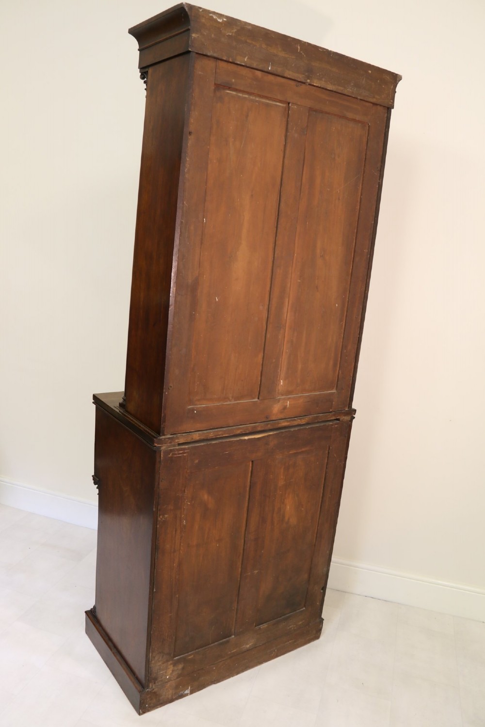 A Regency mahogany secretaire bookcase featuring a glazed upper display cabinet, a drop-front writing drawer with a fitted interior, and reeded side columns. View II