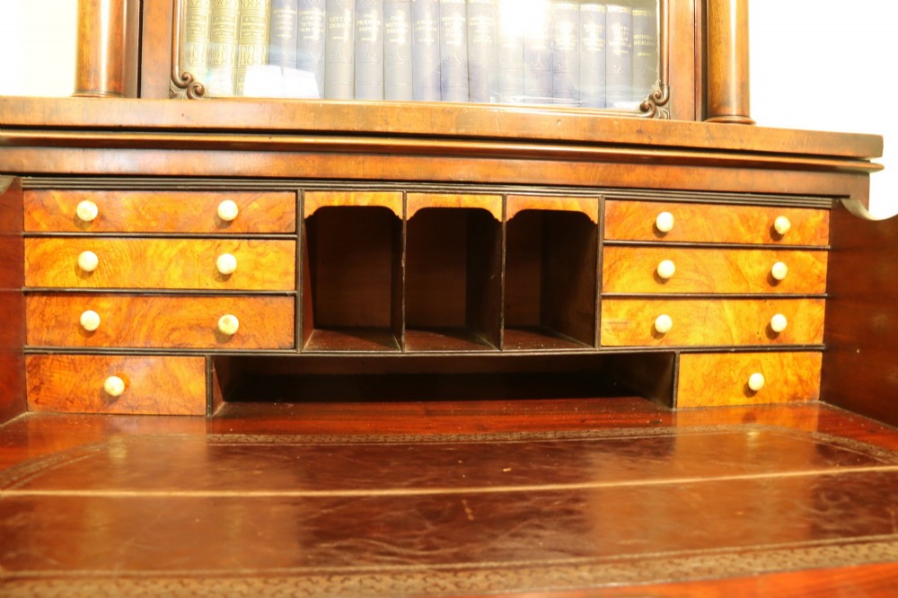 A Regency mahogany secretaire bookcase featuring a glazed upper display cabinet, a drop-front writing drawer with a fitted interior, and reeded side columns. View III