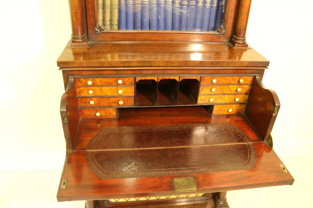 A Regency mahogany secretaire bookcase featuring a glazed upper display cabinet, a drop-front writing drawer with a fitted interior, and reeded side columns. View IV