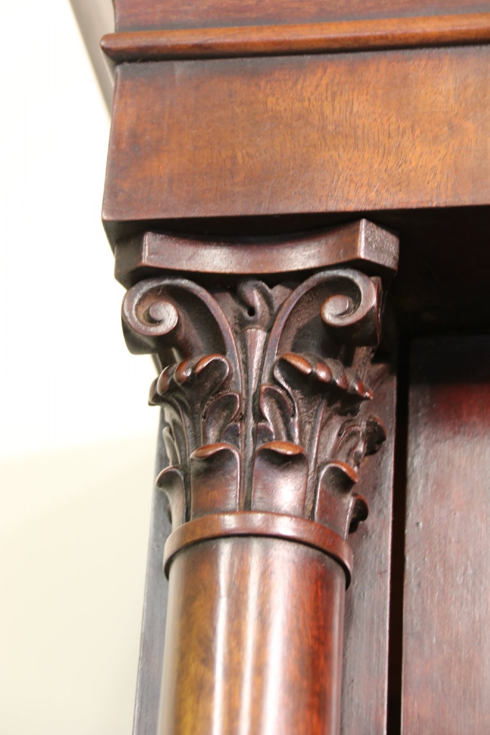 A Regency mahogany secretaire bookcase featuring a glazed upper display cabinet, a drop-front writing drawer with a fitted interior, and reeded side columns. View VI