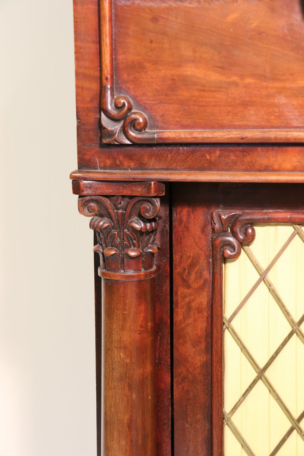 A Regency mahogany secretaire bookcase featuring a glazed upper display cabinet, a drop-front writing drawer with a fitted interior, and reeded side columns. View VII