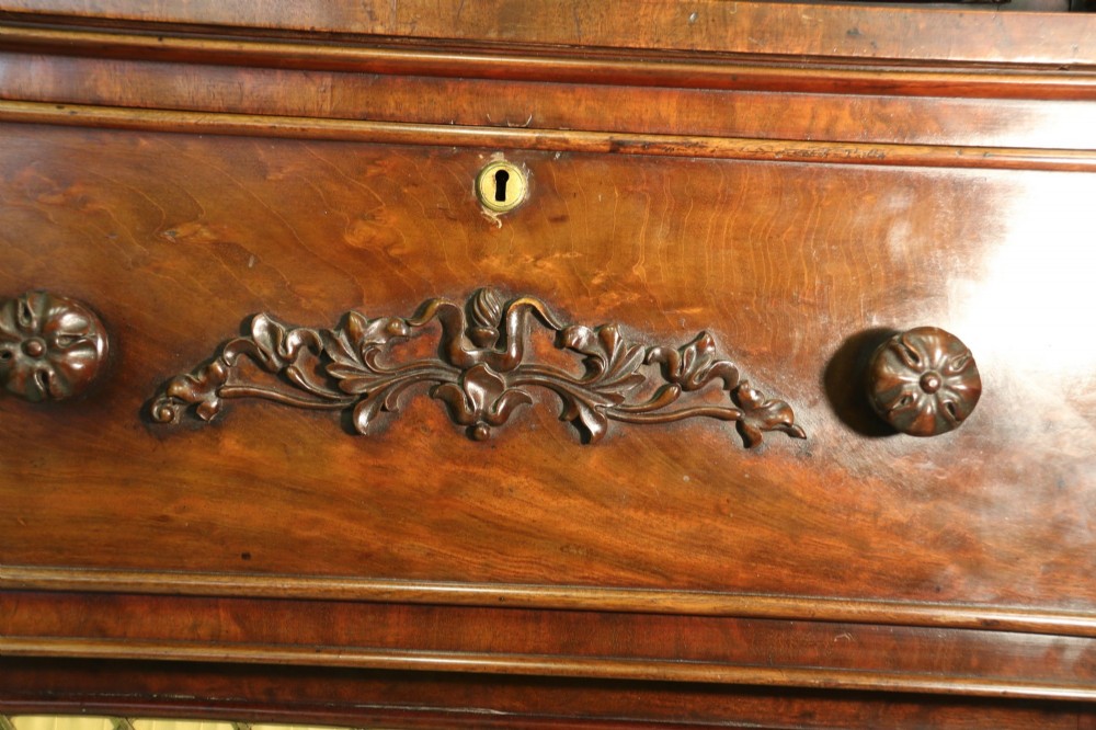 A Regency mahogany secretaire bookcase featuring a glazed upper display cabinet, a drop-front writing drawer with a fitted interior, and reeded side columns. View IX