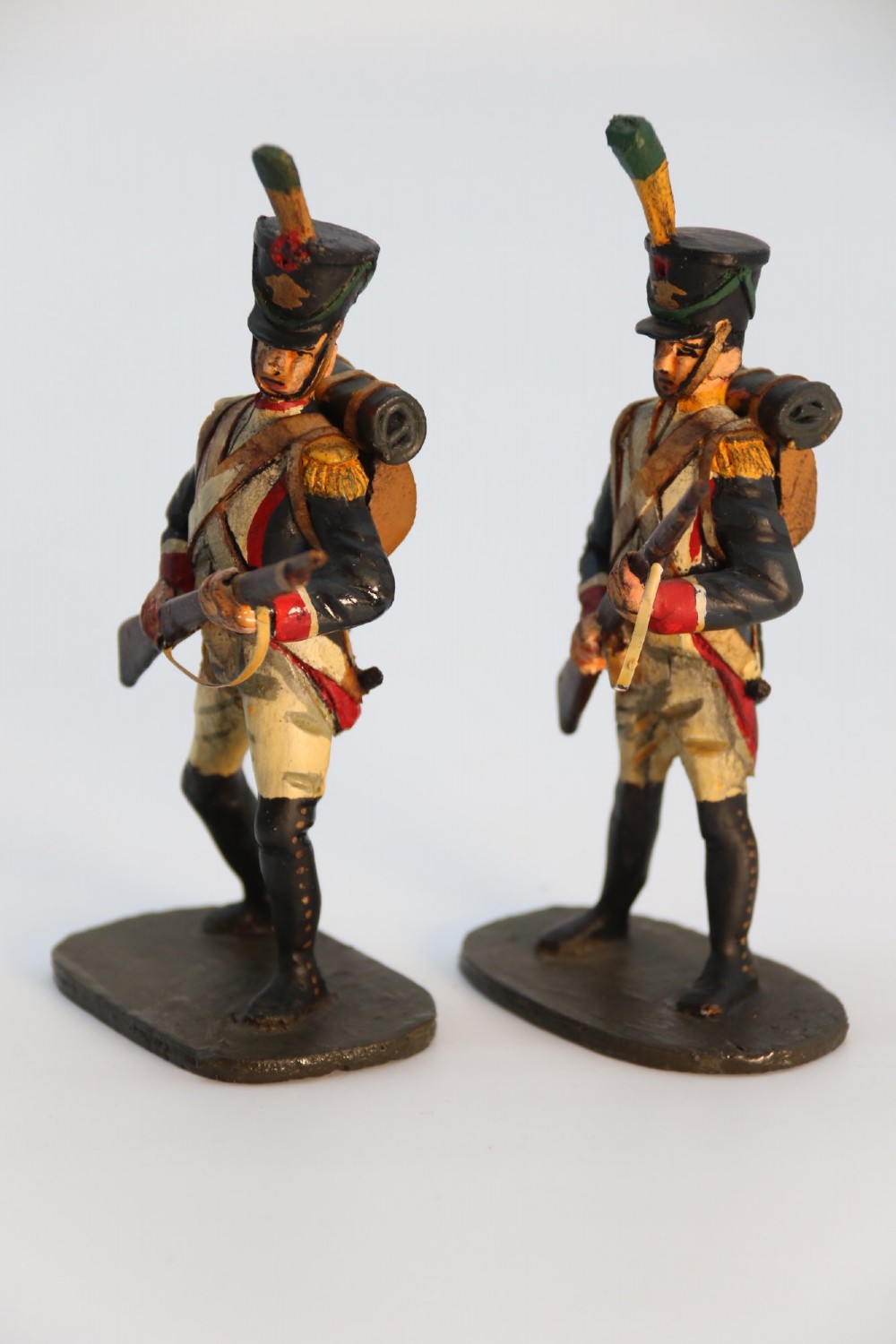 A group of ten hand-carved and painted wooden figures depicting Napoleonic infantry soldiers with muskets standing on individual oval bases. View VII