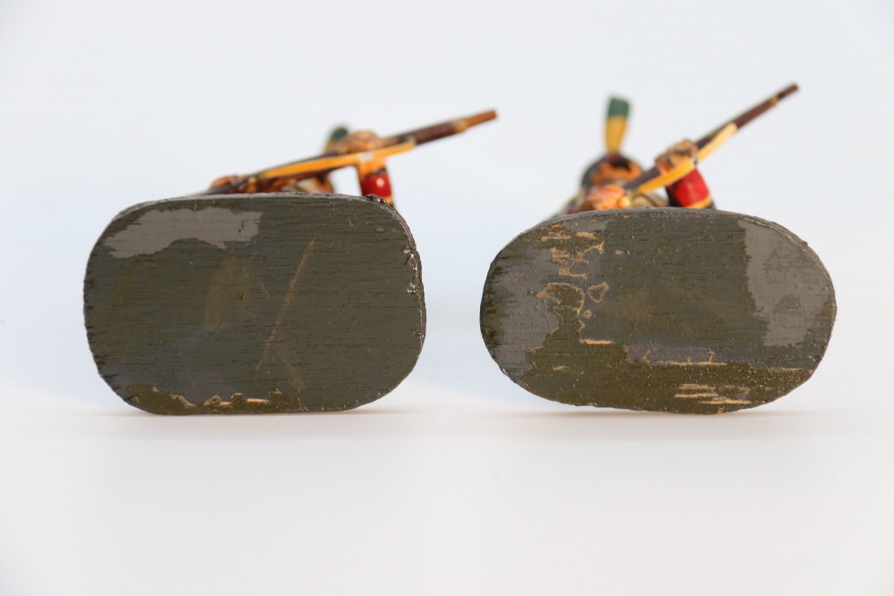 A group of ten hand-carved and painted wooden figures depicting Napoleonic infantry soldiers with muskets standing on individual oval bases. View VIII