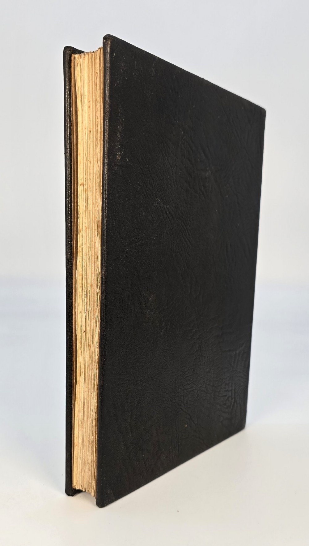 An Edwardian black leather bound edition of the Rubaiyat of Omar Khayyam featuring gilt and red embellished lettering with geometric corner tooling. View III