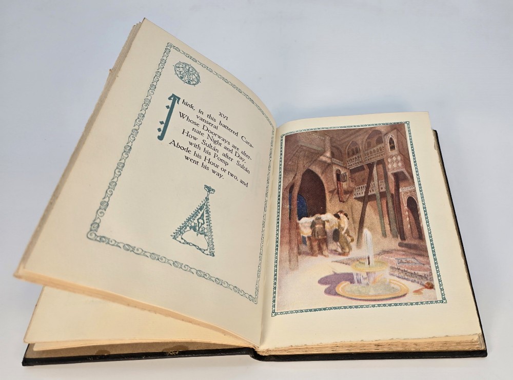 An Edwardian black leather bound edition of the Rubaiyat of Omar Khayyam featuring gilt and red embellished lettering with geometric corner tooling. View VI
