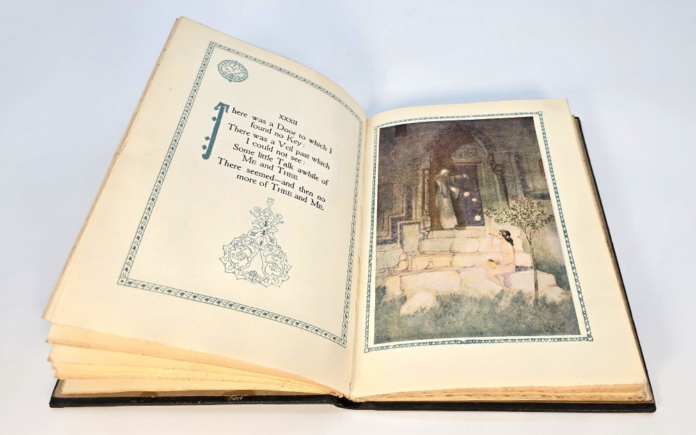 An Edwardian black leather bound edition of the Rubaiyat of Omar Khayyam featuring gilt and red embellished lettering with geometric corner tooling. View VII