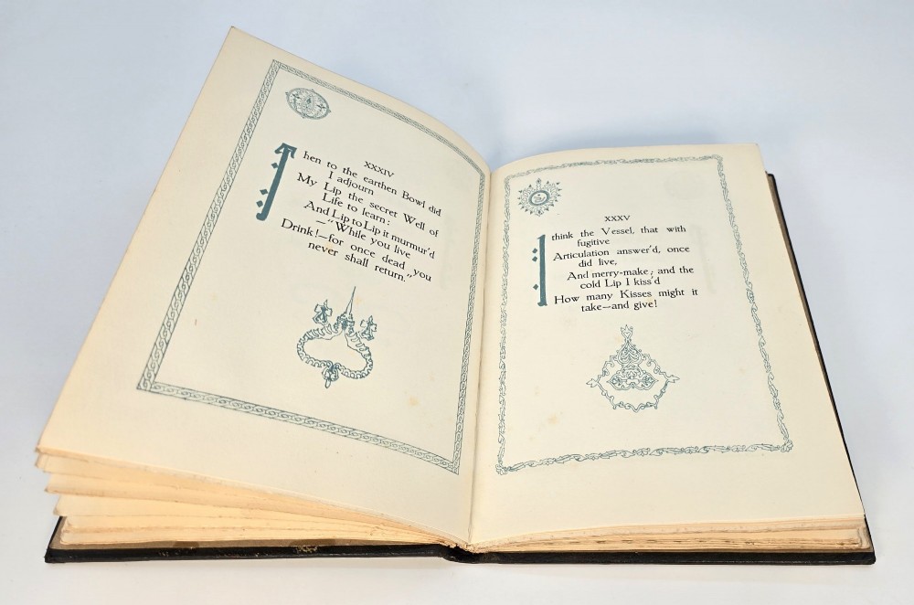 An Edwardian black leather bound edition of the Rubaiyat of Omar Khayyam featuring gilt and red embellished lettering with geometric corner tooling. View VIII