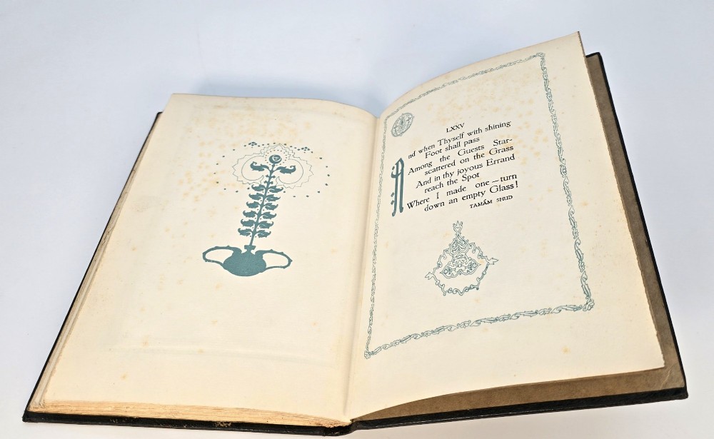 An Edwardian black leather bound edition of the Rubaiyat of Omar Khayyam featuring gilt and red embellished lettering with geometric corner tooling. View XI