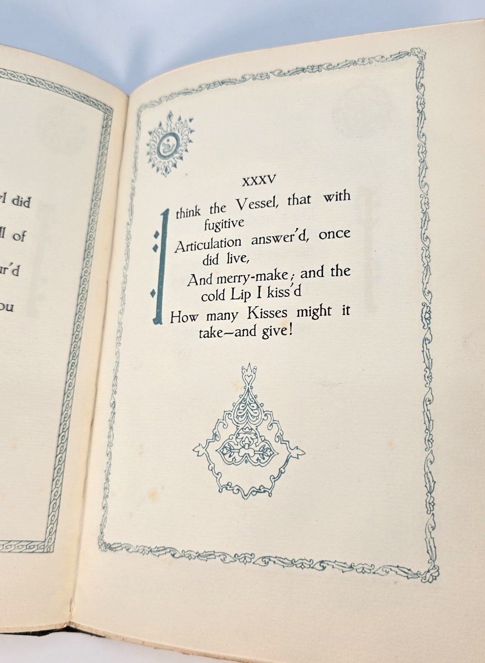 An Edwardian black leather bound edition of the Rubaiyat of Omar Khayyam featuring gilt and red embellished lettering with geometric corner tooling. View XIII