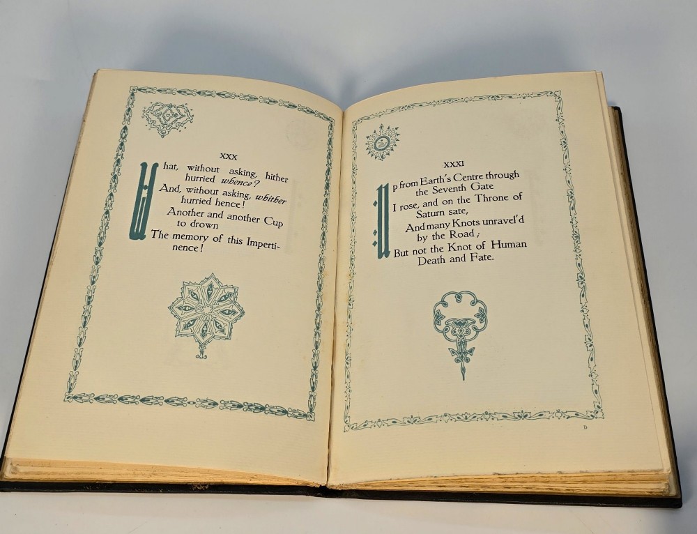 An Edwardian black leather bound edition of the Rubaiyat of Omar Khayyam featuring gilt and red embellished lettering with geometric corner tooling. View XIV
