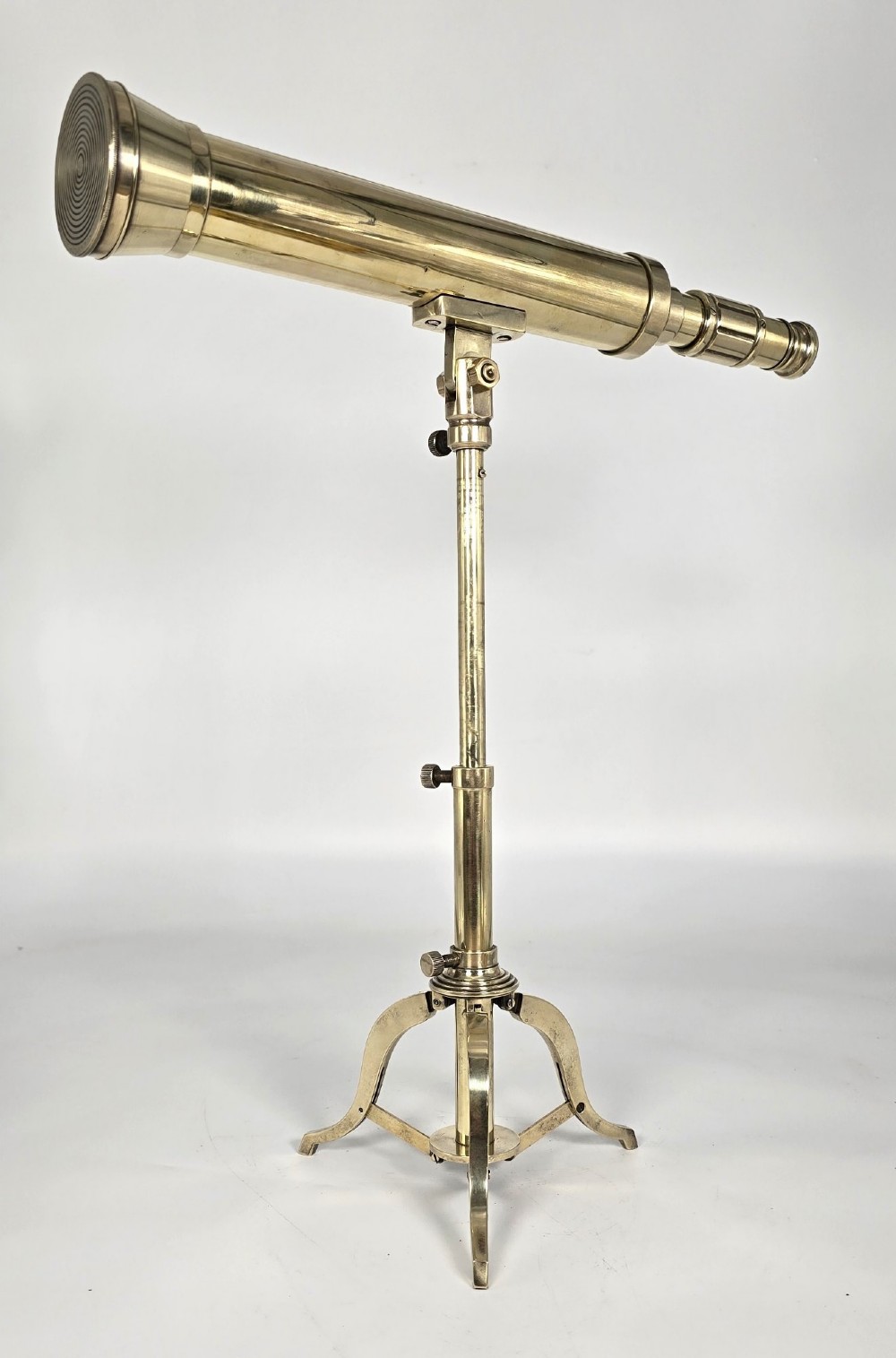 A Victorian brass table telescope mounted on a folding brass tripod stand. View VIII