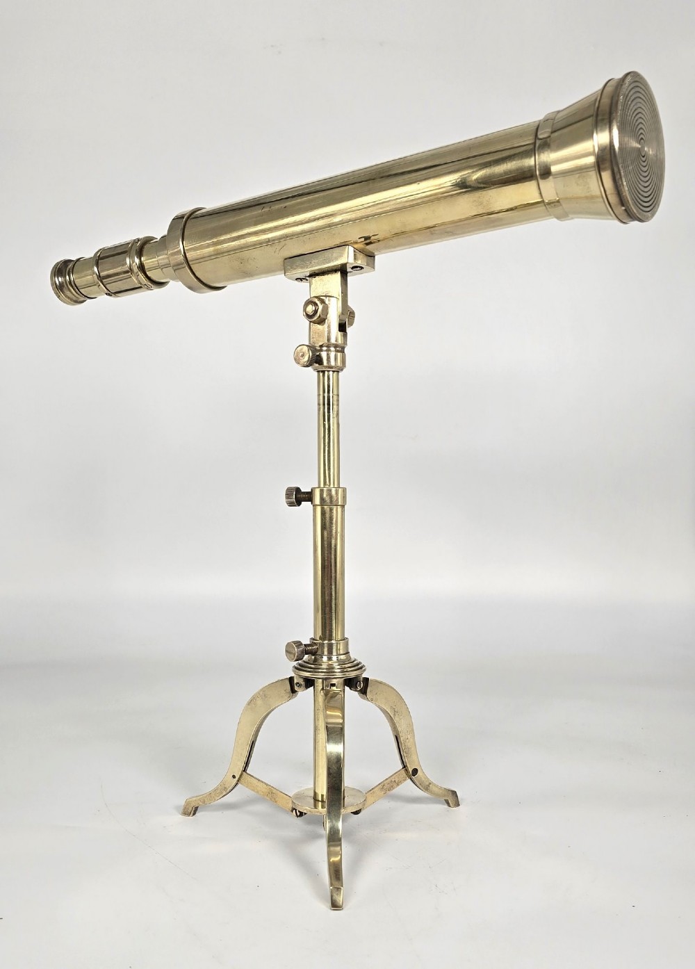 A Victorian brass table telescope mounted on a folding brass tripod stand. View IX