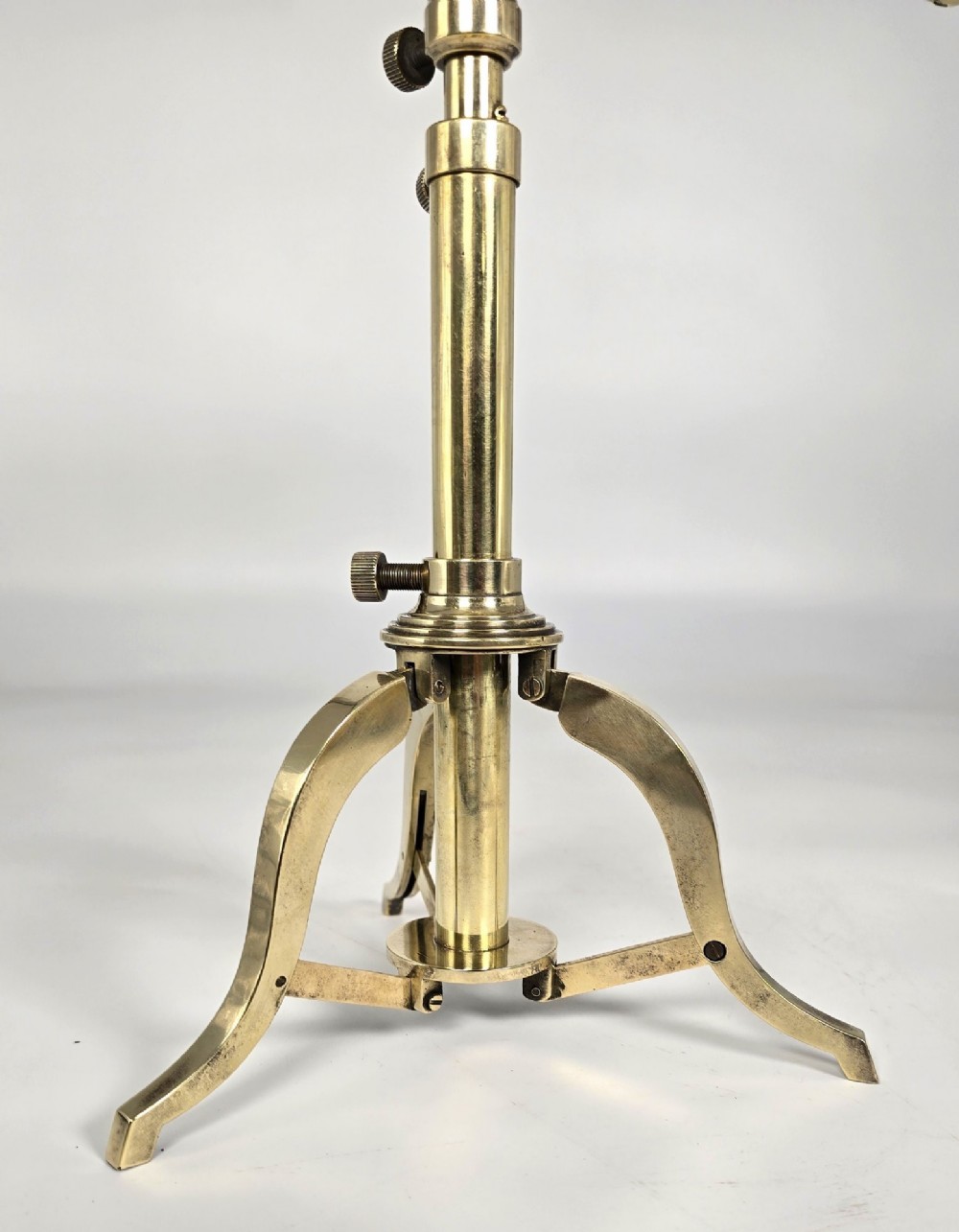 A Victorian brass table telescope mounted on a folding brass tripod stand. View X