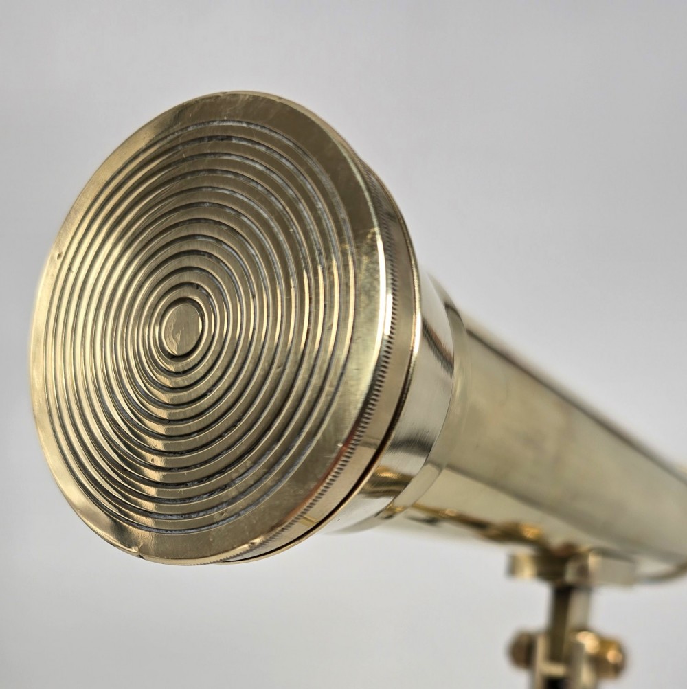 A Victorian brass table telescope mounted on a folding brass tripod stand. View XI