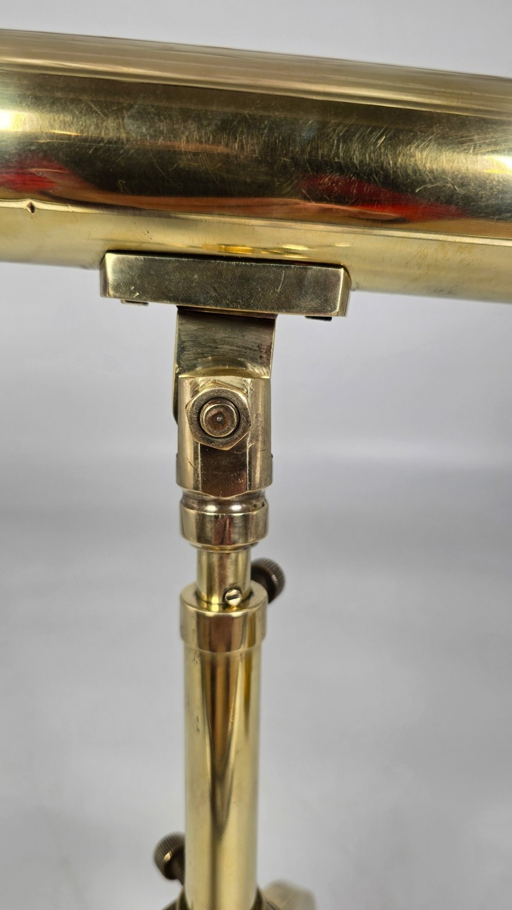 A Victorian brass table telescope mounted on a folding brass tripod stand. View XIII