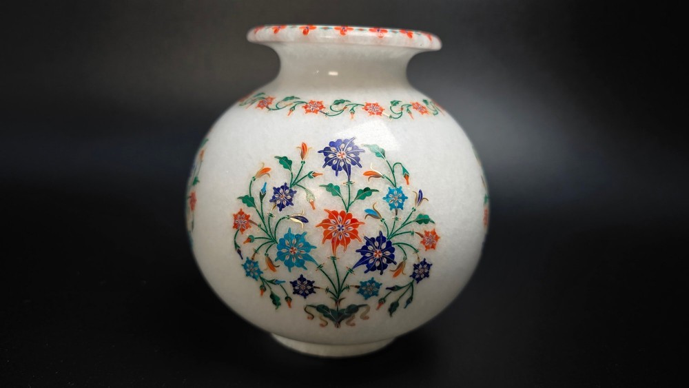 A globular white marble vase decorated with colourful floral inlays made from semi-precious stones. View X