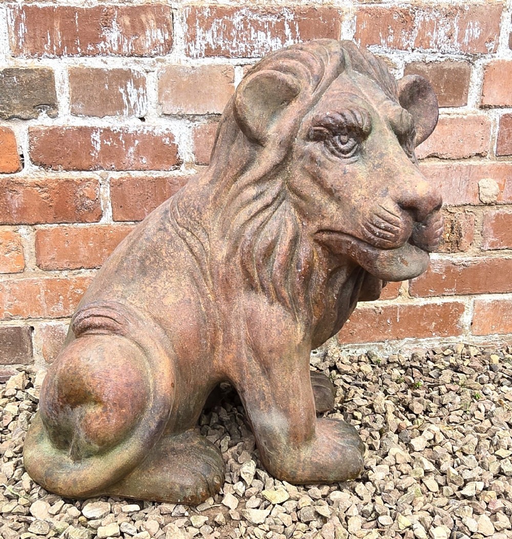 A pair of hand-sculpted Italian terracotta seated lions with weathered patination. View II
