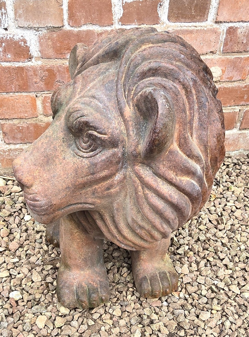 A pair of hand-sculpted Italian terracotta seated lions with weathered patination. View III