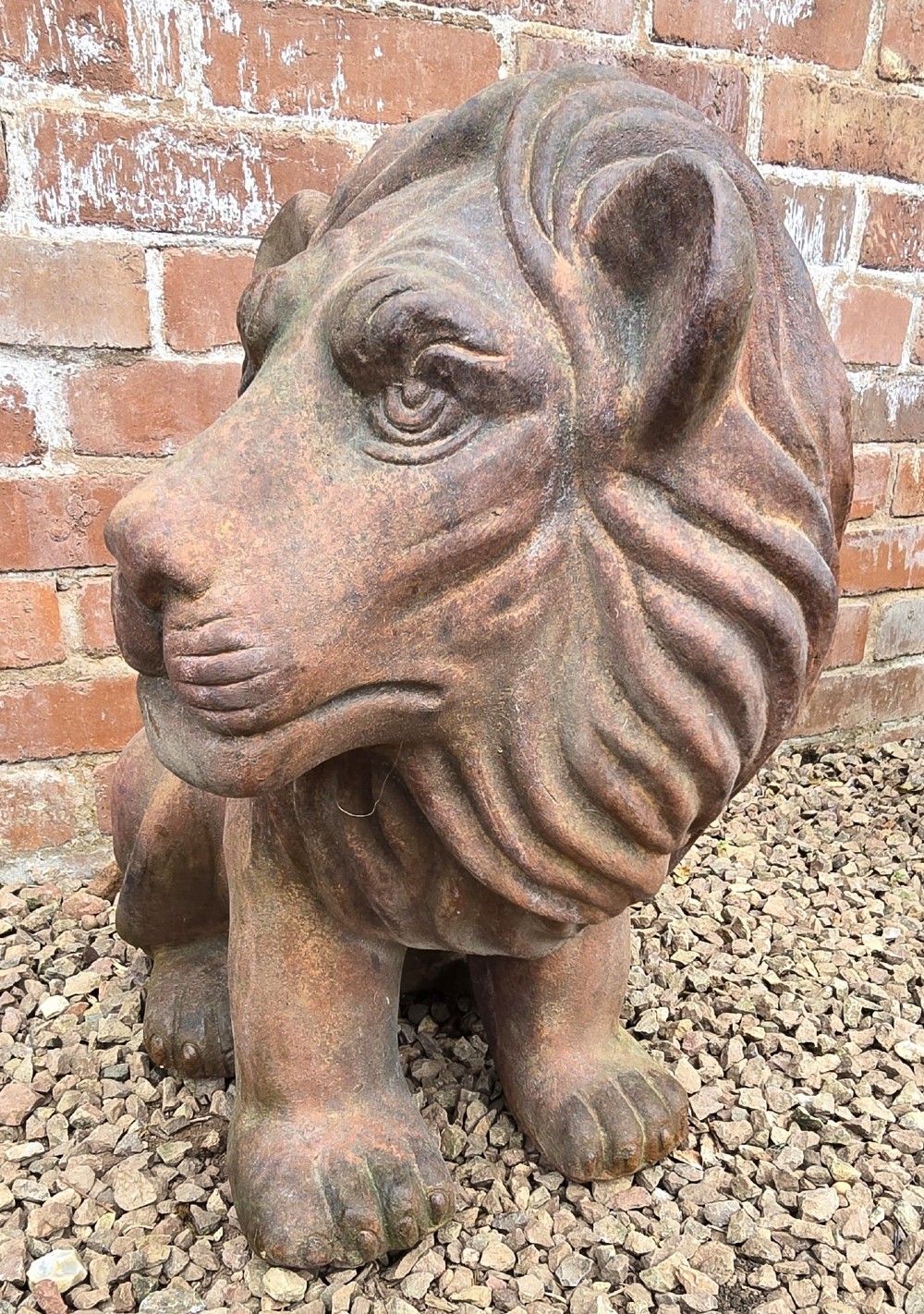 A pair of hand-sculpted Italian terracotta seated lions with weathered patination. View IV