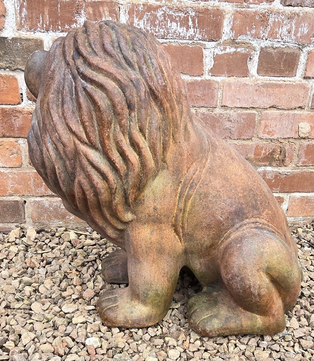 A pair of hand-sculpted Italian terracotta seated lions with weathered patination. View V