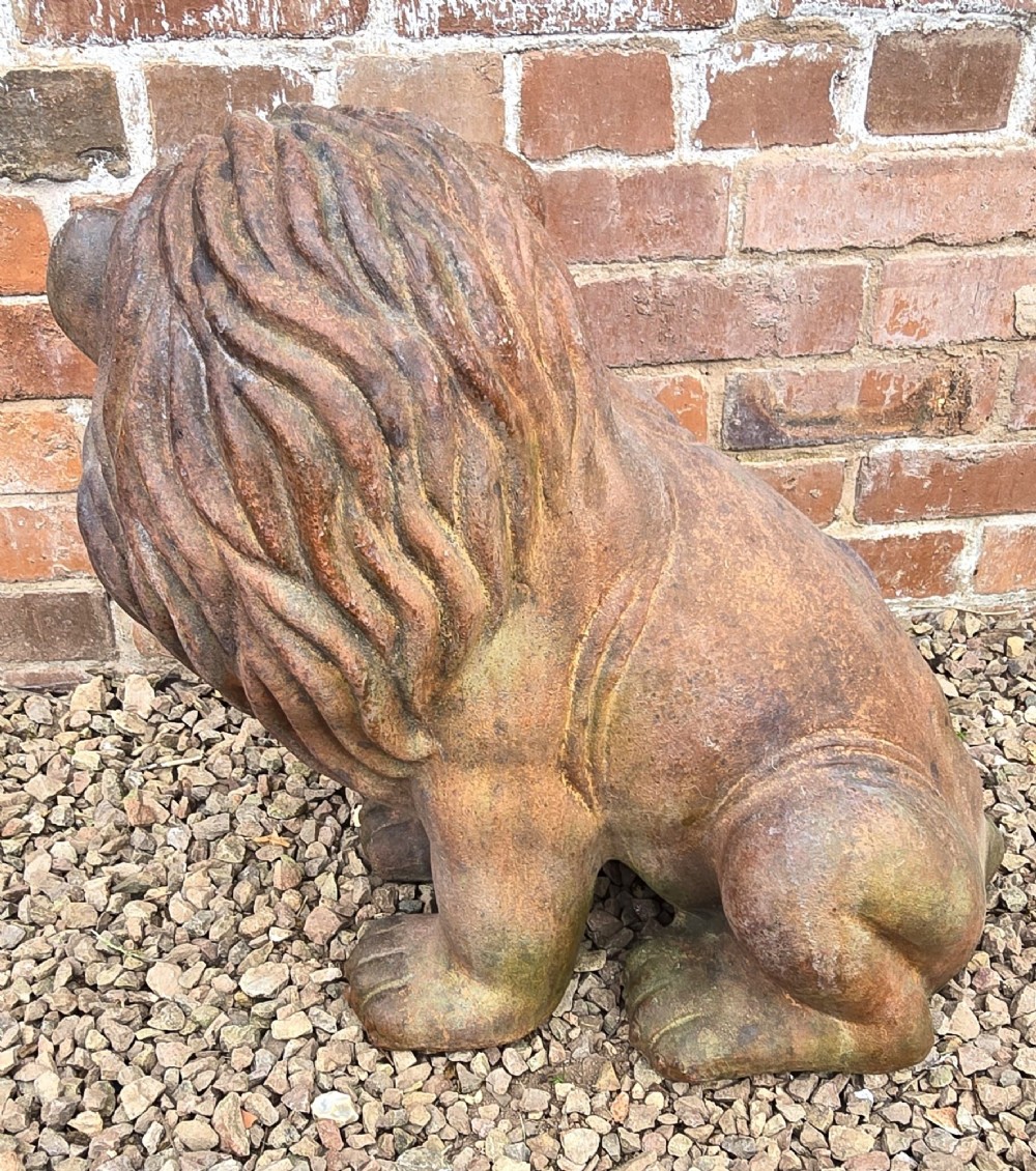 A pair of hand-sculpted Italian terracotta seated lions with weathered patination. View VI