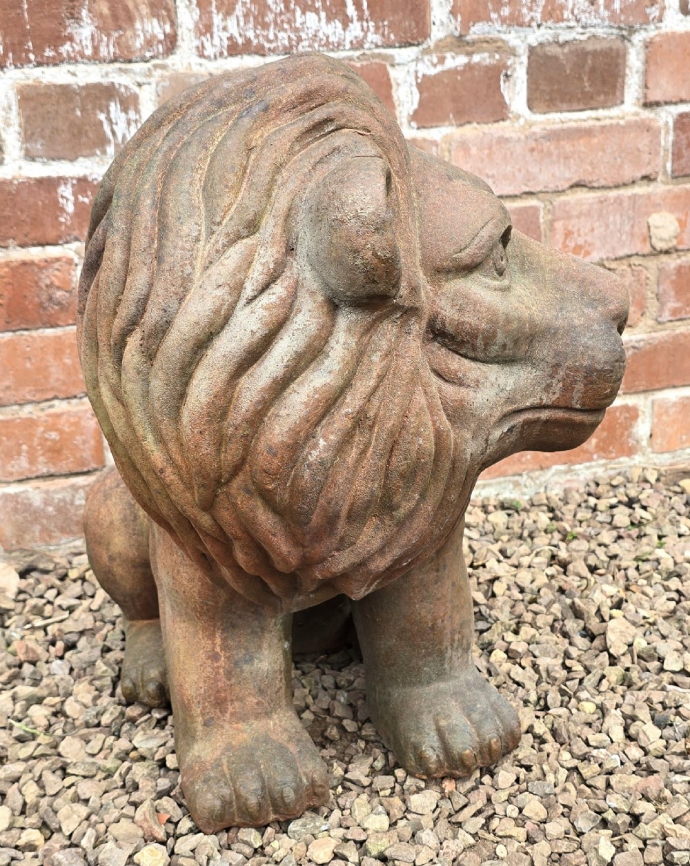 A pair of hand-sculpted Italian terracotta seated lions with weathered patination. View IX