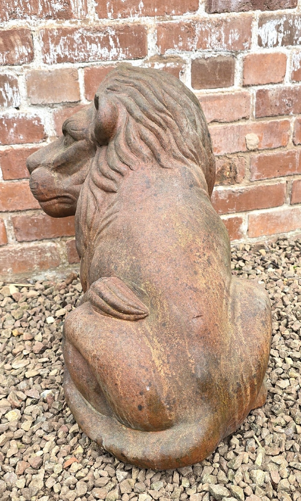 A pair of hand-sculpted Italian terracotta seated lions with weathered patination. View XI