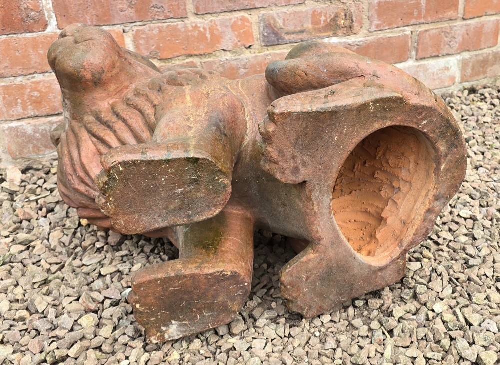A pair of hand-sculpted Italian terracotta seated lions with weathered patination. View XII
