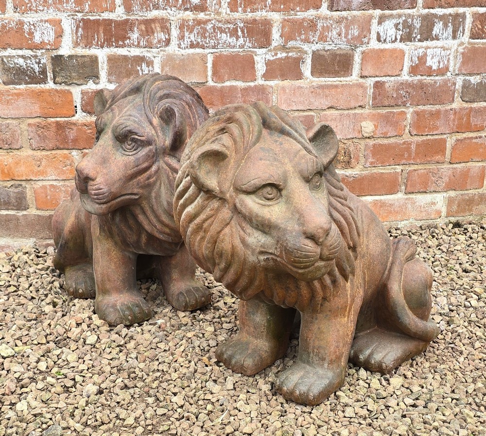 A pair of hand-sculpted Italian terracotta seated lions with weathered patination. View XIV