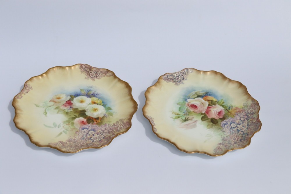 A silver-plated double frame holding two floral porcelain plates alongside a fitted cream jug and sugar bowl. View III