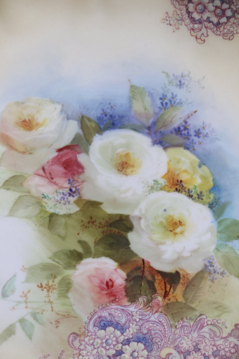 A silver-plated double frame holding two floral porcelain plates alongside a fitted cream jug and sugar bowl. View IV