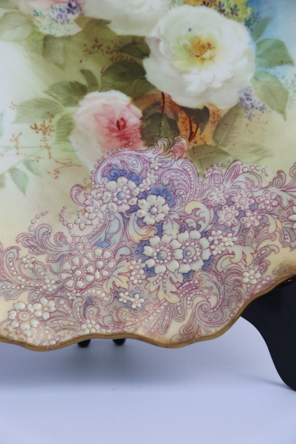 A silver-plated double frame holding two floral porcelain plates alongside a fitted cream jug and sugar bowl. View V