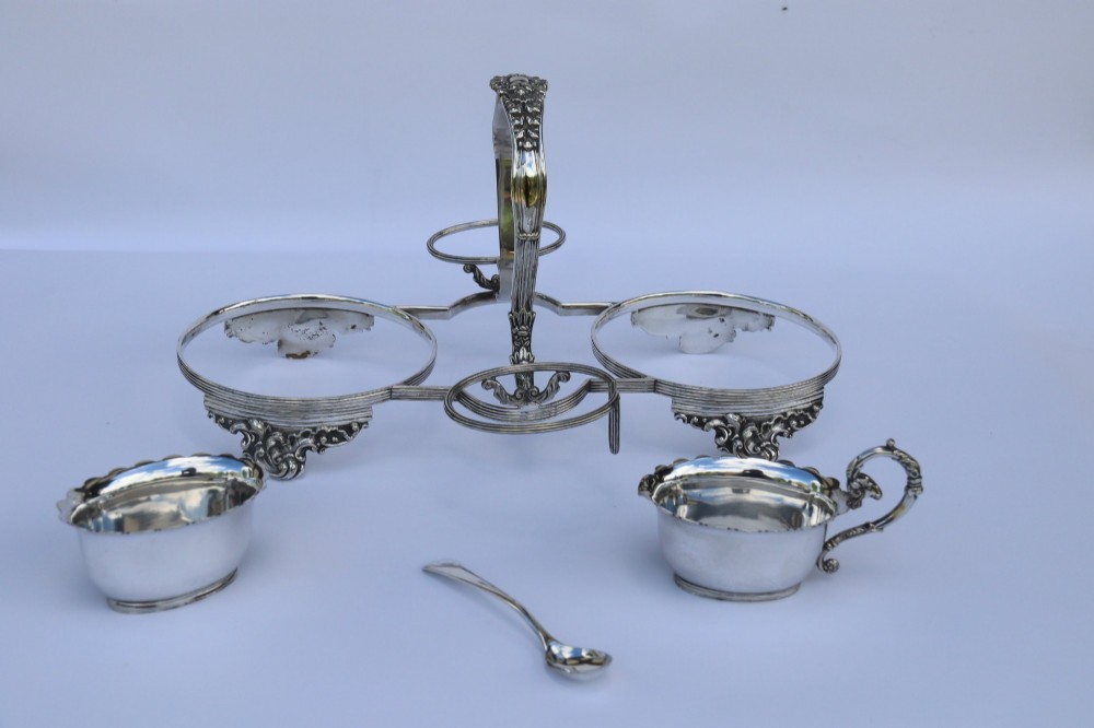 A silver-plated double frame holding two floral porcelain plates alongside a fitted cream jug and sugar bowl. View VI
