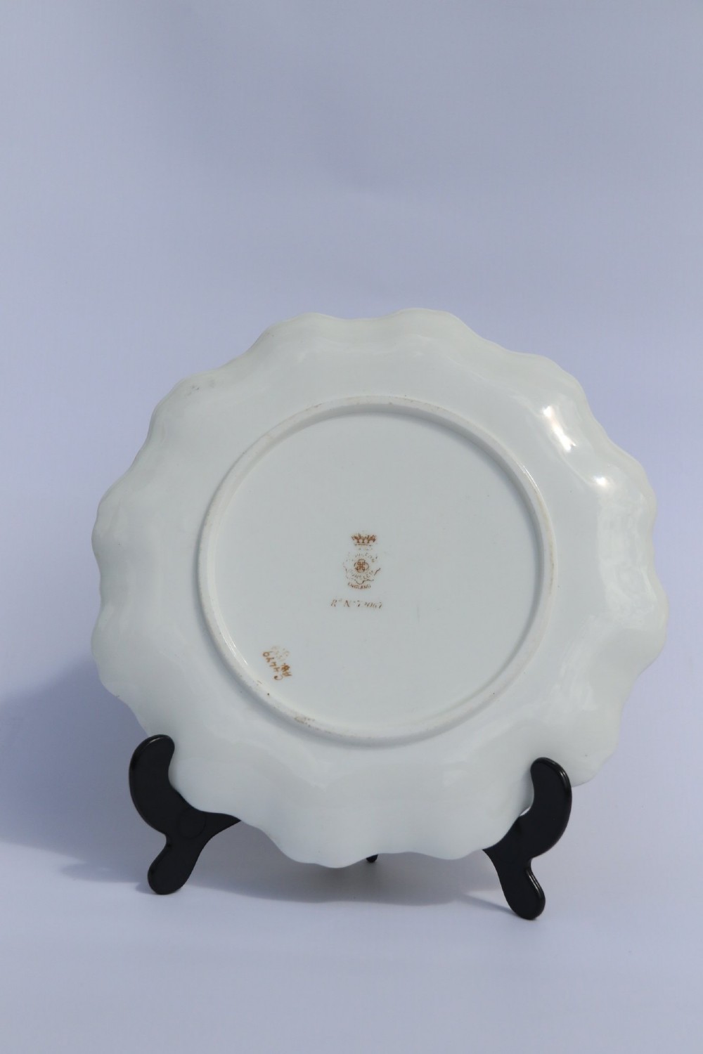 A silver-plated double frame holding two floral porcelain plates alongside a fitted cream jug and sugar bowl. View VII