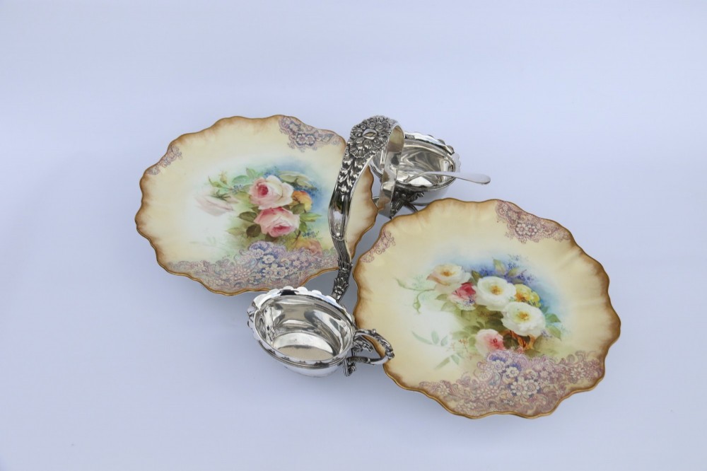 A silver-plated double frame holding two floral porcelain plates alongside a fitted cream jug and sugar bowl. View XIV